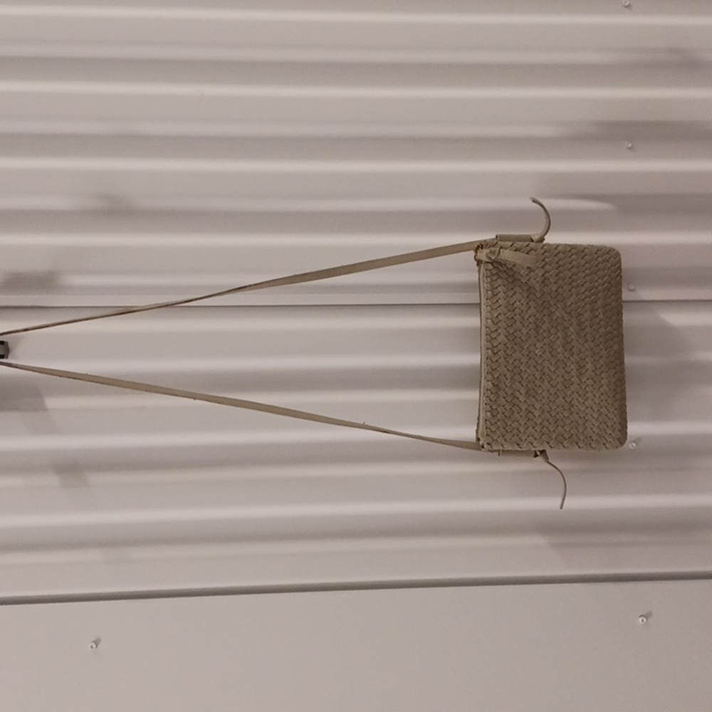 Madewell woven leather crossbody bag in a light sage green.